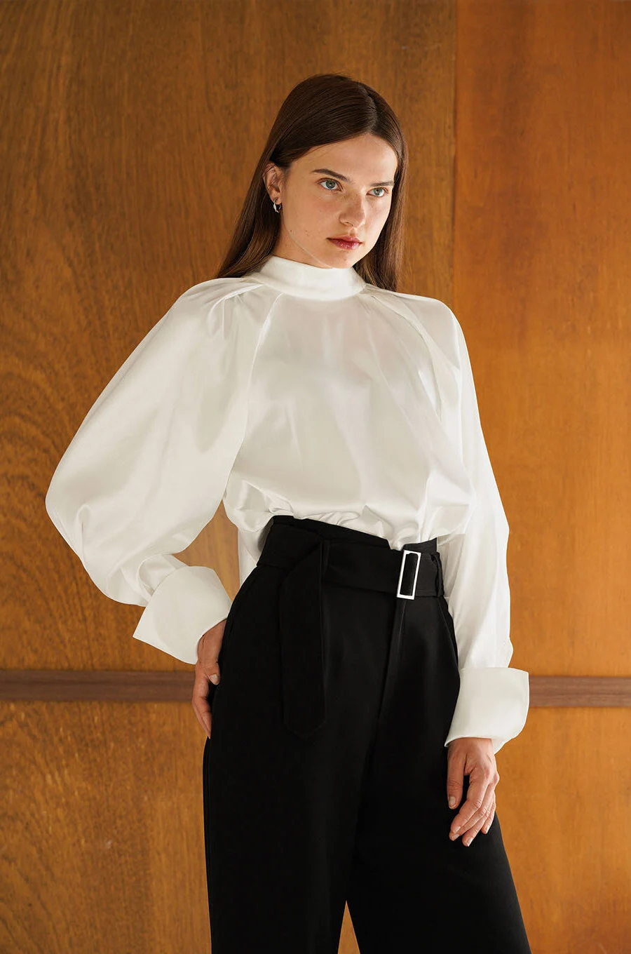 CopyIvory-colored high-necked shirt with sculpted shoulders